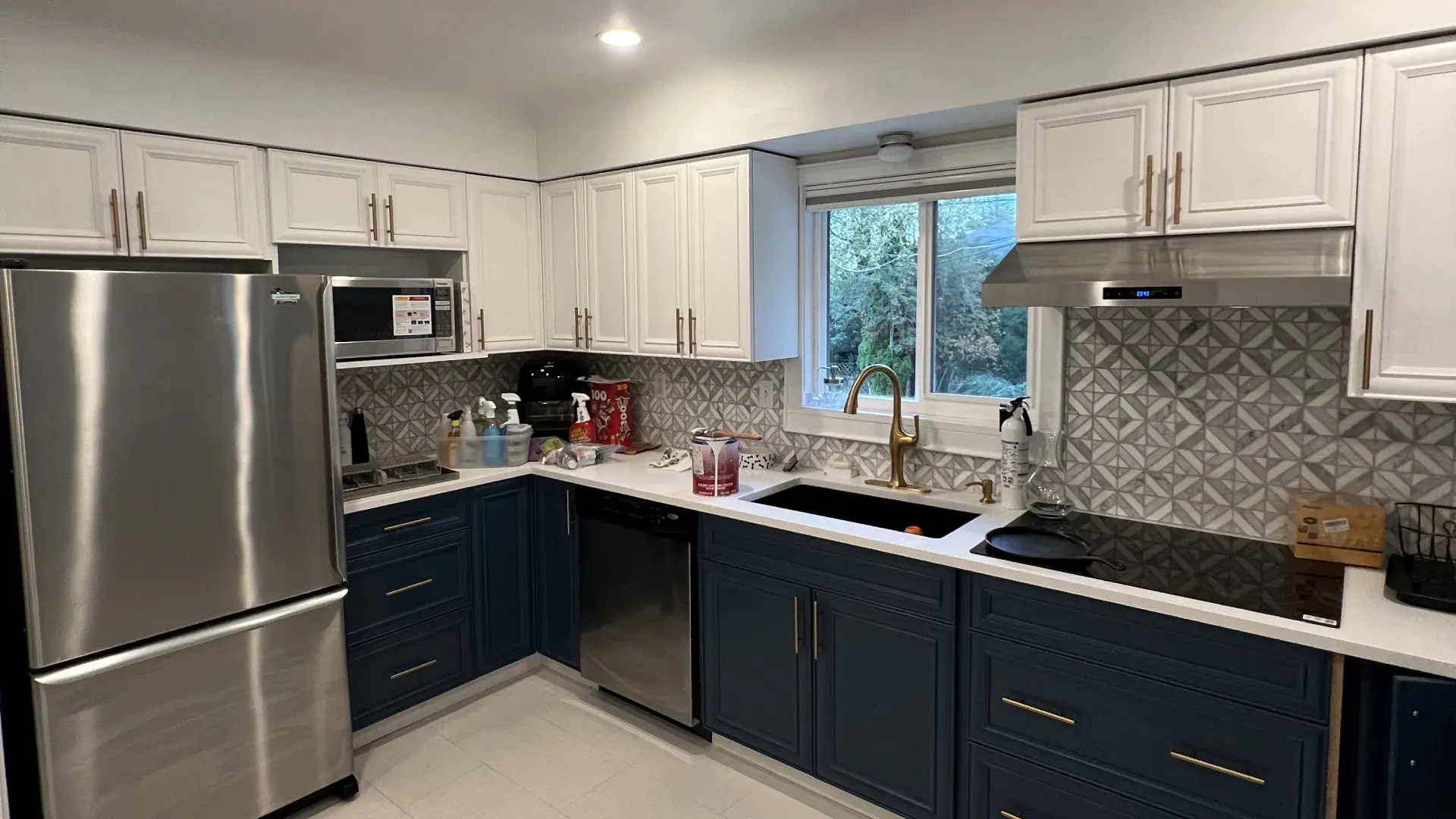 Cabinet refinishing — navy and white refinished kitchen cabinets